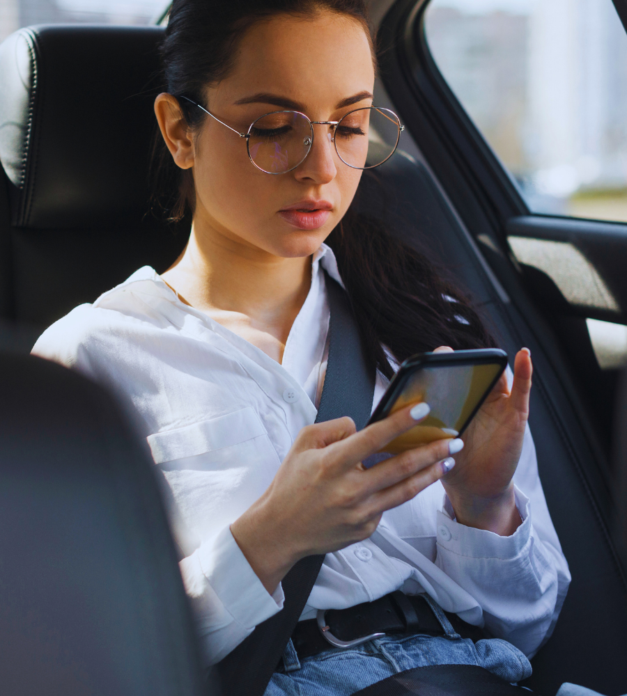 A-girl-wearing-glasses-holding-mobile-traveling-with-airport-shuttle-bus-perth